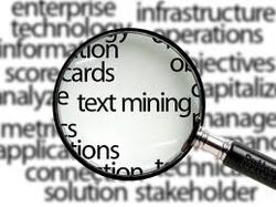 a maginifying glass is over a selection of words, enhancing the term, "text mining."
